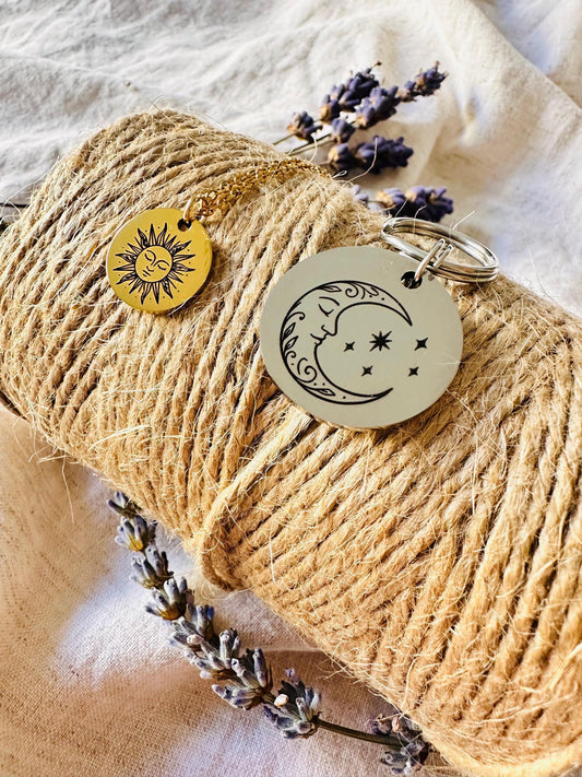 Keychain and Dog Tag with sun and moon design on a roll of twine with lavender flowers