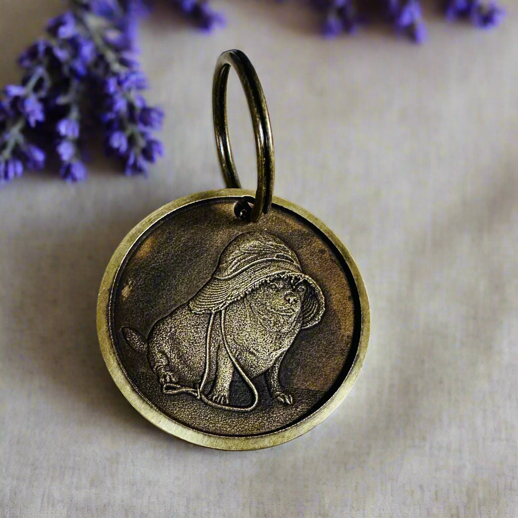 Brass id tag with dog engraving on wood