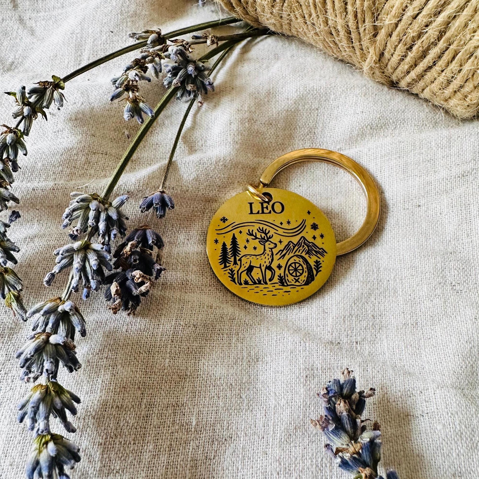 Leo zodiac keychain on a textured fabric background with lavender flowers
