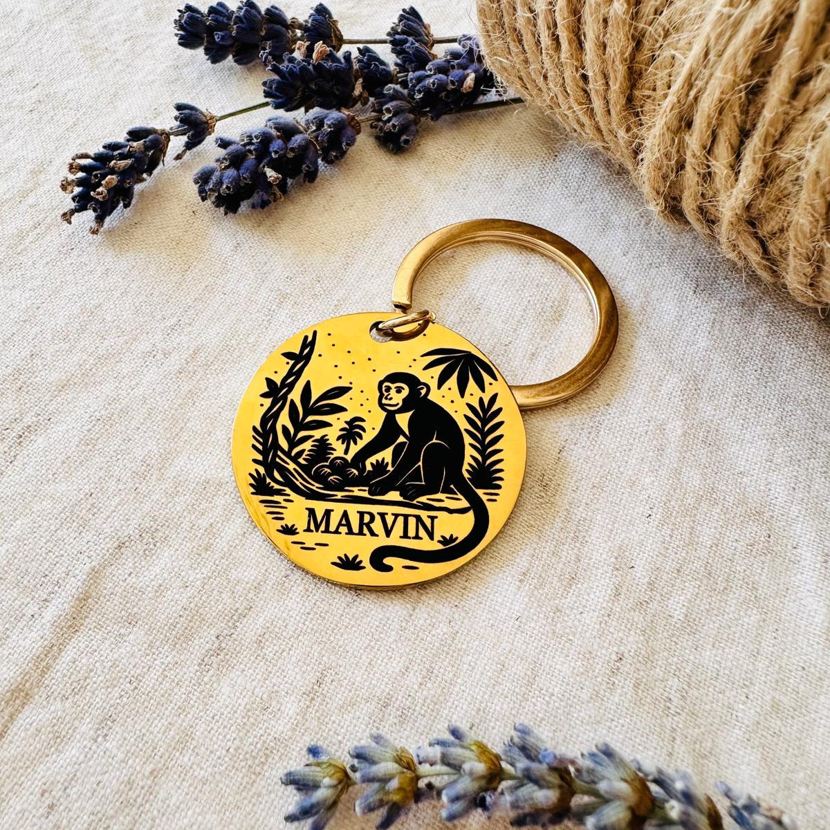 Pet id with monkey design and 'Marvin' text on a textured surface with lavender and twine.